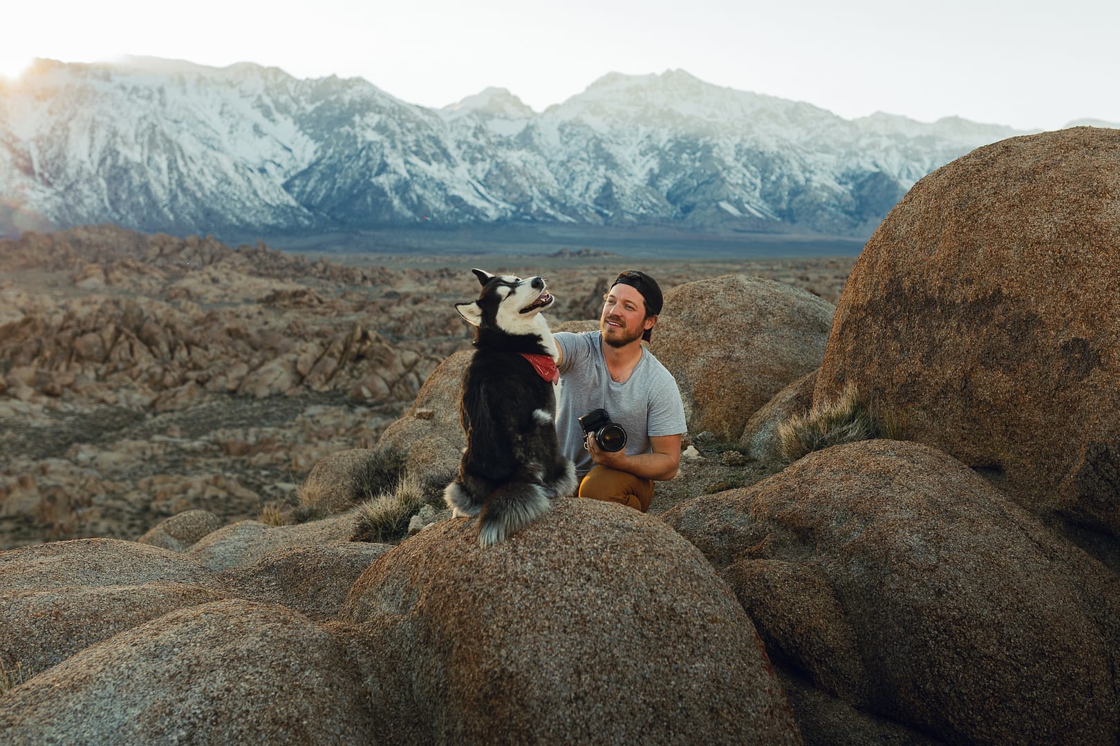 man petting happy husky dog foothills sierra nevada