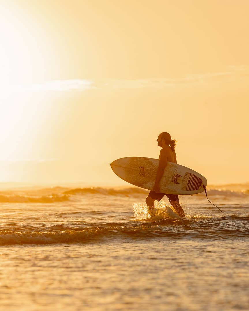 Surfer on west coast catching swell in california